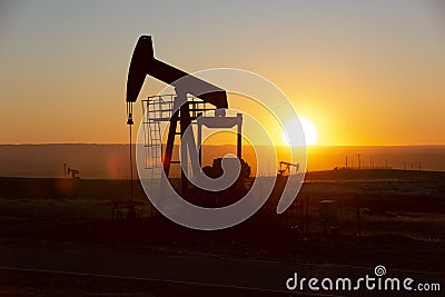 View of Oil Well Pumpjack at Sunset Oil Industry Stock Photo