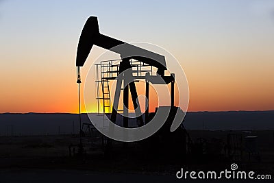 View of Oil Well Pumpjack at Sunset Oil Industry Stock Photo