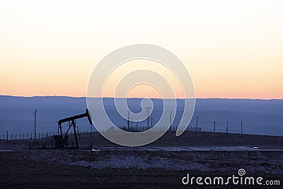 View of Oil Well Pumpjack at Sunset Oil Industry Stock Photo