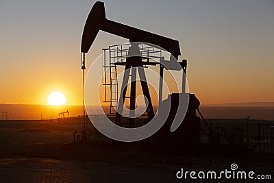 View of Oil Well Pumpjack at Sunset Oil Industry Stock Photo