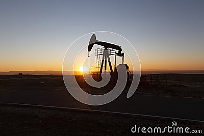 View of Oil Well Pumpjack at Sunset Oil Industry Stock Photo