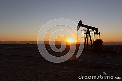 View of Oil Well Pumpjack at Sunset Oil Industry Stock Photo