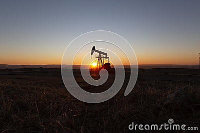 View of Oil Well Pumpjack at Sunset Oil Industry Stock Photo