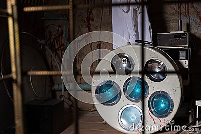 View of old bloodstained surgical operating light lying on the f Stock Photo