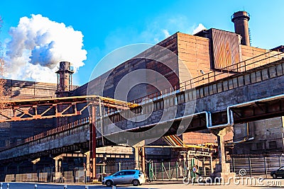 View of old factory with pipe with smoke. Air pollution, environmental damage Editorial Stock Photo