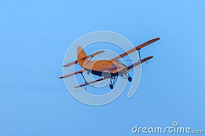 View on an old plane flying againtst the blue sky Stock Photo
