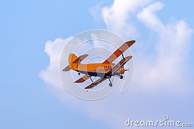 View on an old plane flying againtst the blue sky Stock Photo