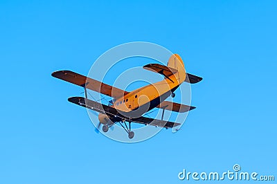 View on an old plane flying againtst the blue sky Stock Photo