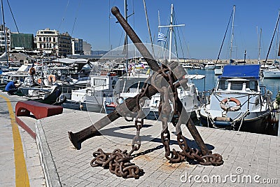 View on old rusty anchor with chain in port of Heraklion near the city center. Stock Photo