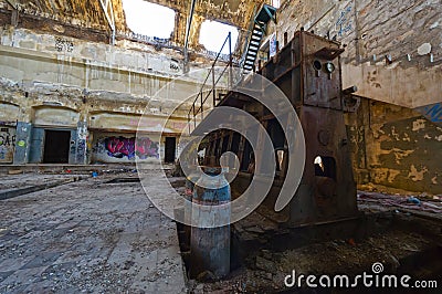 Old rusty engine in an abandoned industrial building Editorial Stock Photo