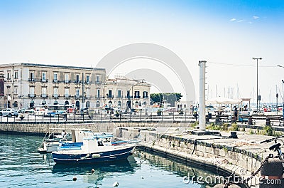 View of old street, facades of ancient buildings and sail boats in seafront of Ortygia Ortigia Island, Syracuse, Sicily, Italy Editorial Stock Photo