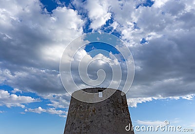 View of old windmill ruins on the coast of Murcia under a blue sky with white clouds Stock Photo