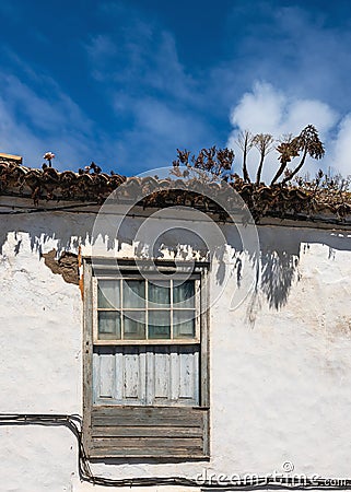 View of an old window with pediment in a traditional colonial facade in the town. Stock Photo