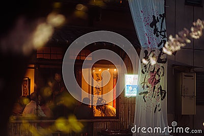 View of an opened curtain before the windows of a Japanese place Stock Photo