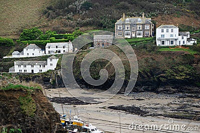 The view from the other side of the water of Doc Martin`s home and Burt and Al Large`s restaurant on the hill with other houses. Editorial Stock Photo