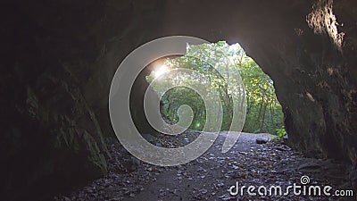 View of the exit of the cave with sunlight Stock Photo