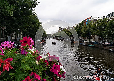 View Over Amsterdam Canal with Flowers Editorial Stock Photo