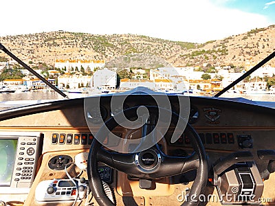 View over the bow of a large luxury motor yacht with bridge area on tropical open sea with mountains Editorial Stock Photo