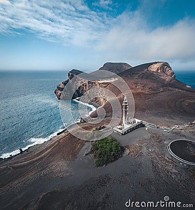 View over Capelinhos volcano, lighthouse of Ponta dos Capelinhos on western coast on Faial island, Azores, Portugal on a Stock Photo