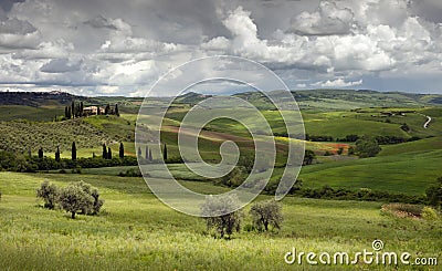 View over fields, vineyards, olive groves and farmhouses south of Pienza in Val D`Orcia San Quirico Tuscany Italy Stock Photo