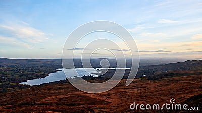 View over the landscapes of Donegal Ireland with a beautiful lake and a blue sky in the background Stock Photo