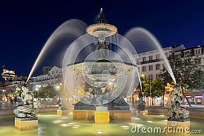 View over Praca de D. Pedro IV or Rossio with bronze fountain, statue of Pedro IV and national theatre, Lisbon, Portugal. Editorial Stock Photo