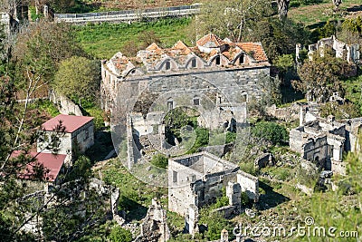 View over the ruins, including ruined Kataponagia lower church, of Kayakoy (Levissi) abandoned village in Mugla Stock Photo