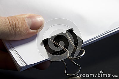 View of a paper clip with stack of blank paper Stock Photo