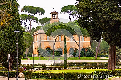 View through the park plants on Casino dell`Orologio, formerly was house of the gardener. Around 1791 was modified on a design by Editorial Stock Photo