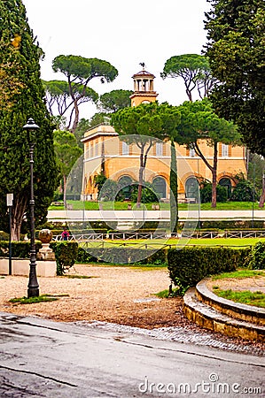 View through the park plants on Casino dell `Orologio, formerly was house of the gardener. Around 1791 was modified on a design by Editorial Stock Photo