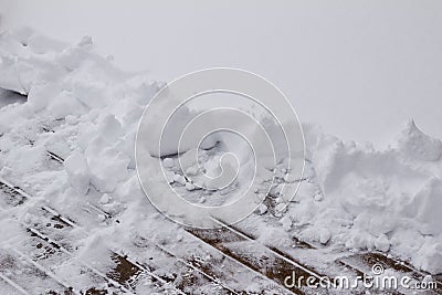 View of a partially shoveled wooden deck with copy space Stock Photo