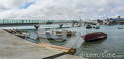 A view past old boats moored on the River Adur at Shoreham, Sussex, UK Stock Photo