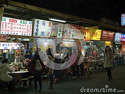 View of people eating in restaurant at Liaoning Street night mar Editorial Stock Photo