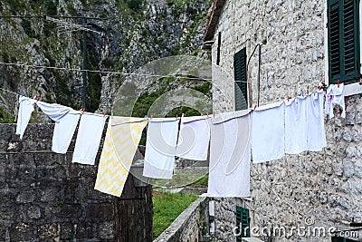 View of picturesque old street in Kotor with airing clothes. Old town of Kotor, Montenegro Stock Photo