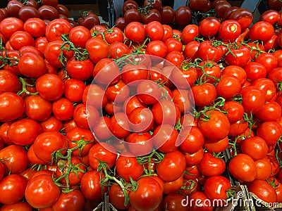 View on pile of countless red ripe raw cherry tomatoes on german market Stock Photo