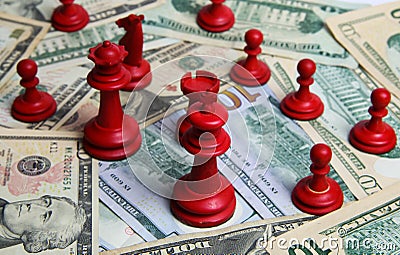 View on pile paper money us dollar banknotes with group red chess pieces Stock Photo