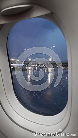 View from the plane to the airport territory in the evening, rainy weather Editorial Stock Photo