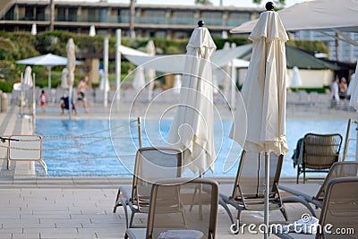 View pool bed, beach chair with umbrellas chaise lounges near the pool Stock Photo