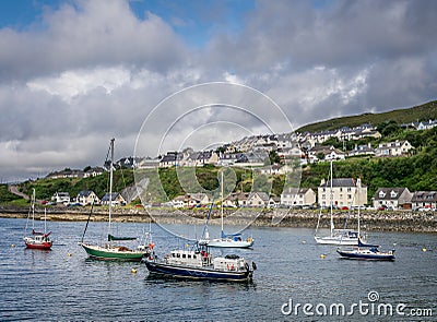 A view of a port with various ships and boats in Mallaig Editorial Stock Photo