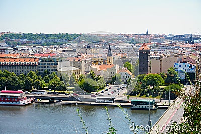 View of Prague with Vltava with ships and amazing buildings with red roofs. Editorial Stock Photo