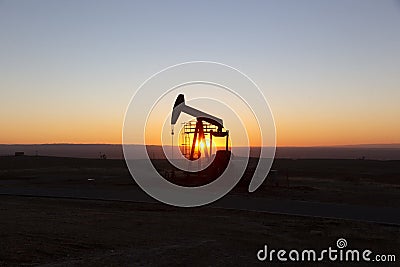 View of Pumpjack at Sunset from Petroleum Area Stock Photo