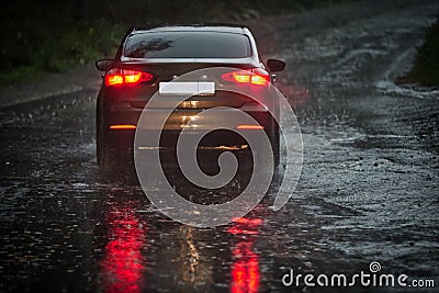 View from a rain-drenched windshield on a car in front. Stock Photo