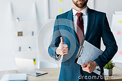 View of recruiter standing and holding clipboard with resume letters while showing thumb up Stock Photo