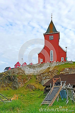 View of the church and traditional Greenland sledges in the foreground in Sisimiut Stock Photo