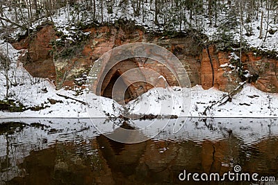 view of red sandstone cliffs, sunny winter day, reflections in the river Stock Photo