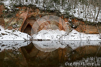 view of red sandstone cliffs, sunny winter day, reflections in the river Stock Photo