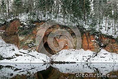 view of red sandstone cliffs, sunny winter day, reflections in the river Stock Photo