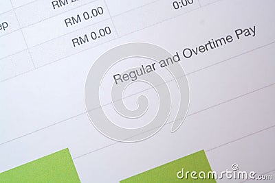 View of a regular and overtime pay sheet paper, with a concept of providing compensation for labor work Stock Photo