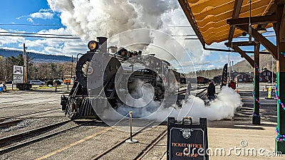 View of a Restored Narrow Gauge Steam Locomotive Blowing Smoke and Steam on a Winters Day Editorial Stock Photo
