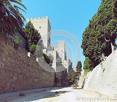 Rhodes castle view of walls battlements and towers taken from the dry moat with blue sky Stock Photo